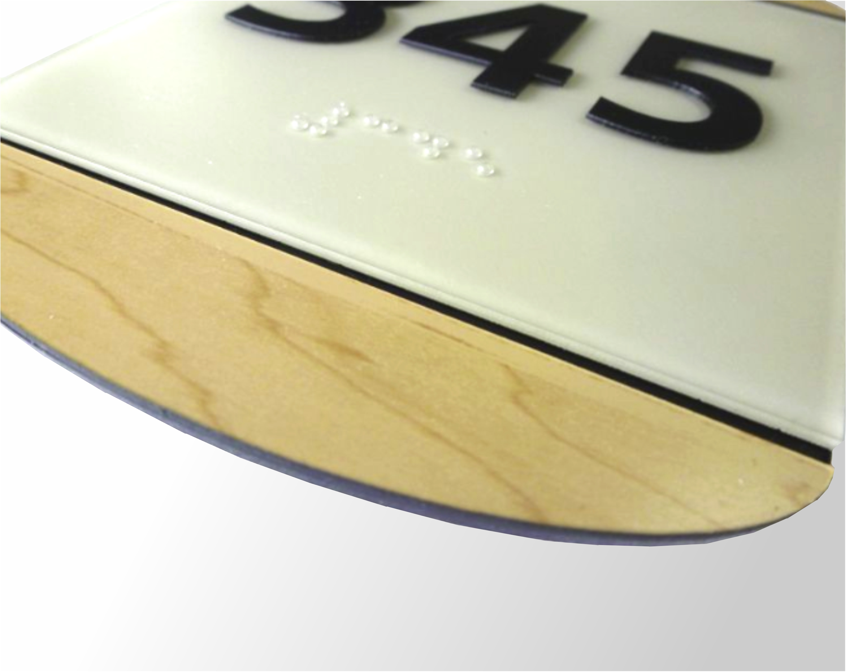 Wedge ADA braille sign with layered architectural construction and dimensional design